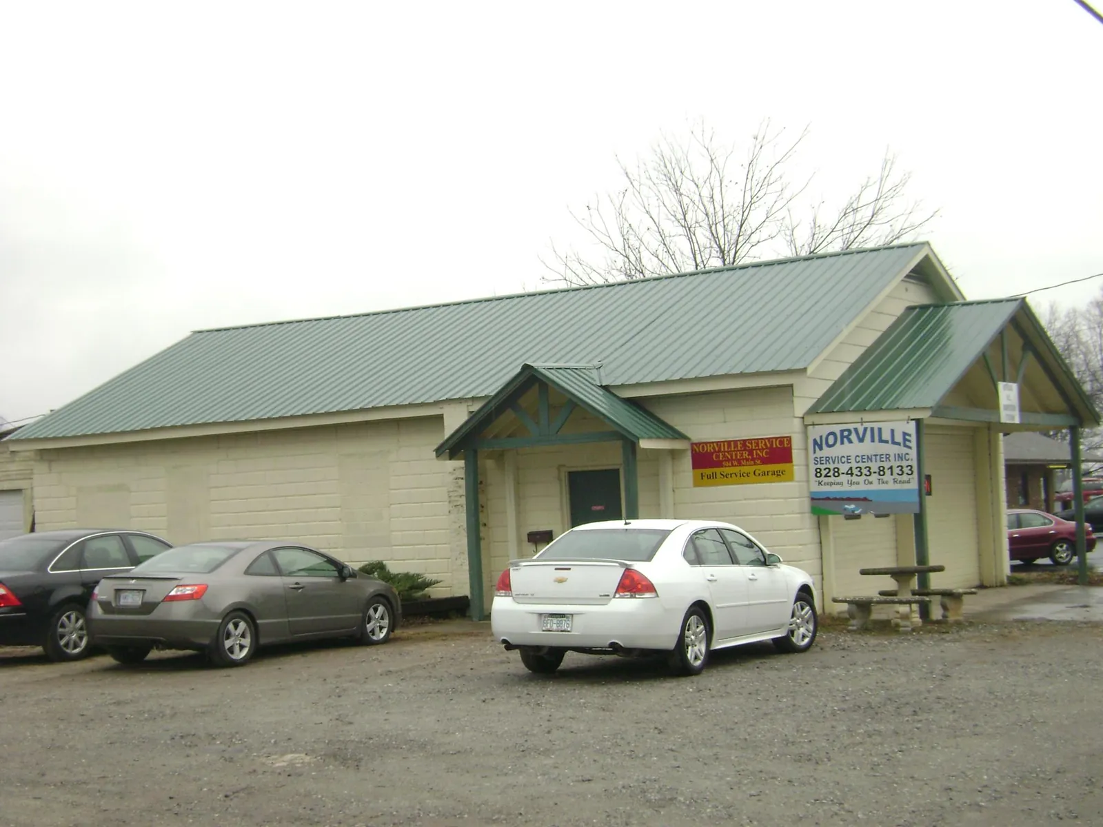 Green metal roof on a service garage with a covered entry in Mocksville